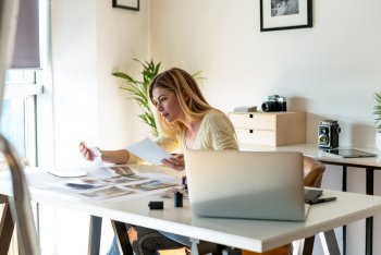 junge Frau sitzt am Schreibtisch